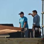 President Brown helping lift frames to build walls. Photo Credit: Jim Reme