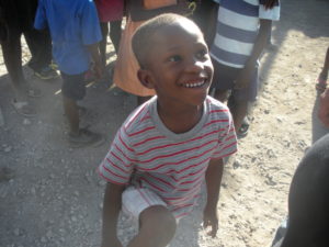 A photo of a happy child, full of life in the presence of 'Hawks.' By Kelly Craig. 