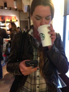 A busy patron sips some delightful Starbucks concoction. By Caitlyn Bahrenburg. 