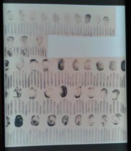 Artwork by Jozef Szajna titled "Our Biographies," with prisoners' faces depicted with their fingerprints.