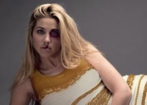 The first part of the Salvation Army ad shows a bruised woman with a white and gold version of the dress.